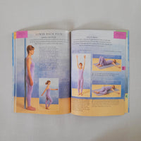 Open book showing pages with yoga illustrations and text on a plain background