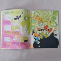 Open book with colourful illustrations on a gray background