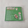 CD back cover of 'Christmas in New Zealand' with Santa Claus illustration on a textured surface