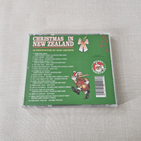 CD back cover of 'Christmas in New Zealand' with Santa Claus illustration on a textured surface