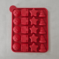 Red silicone mold with various shapes on a grey background