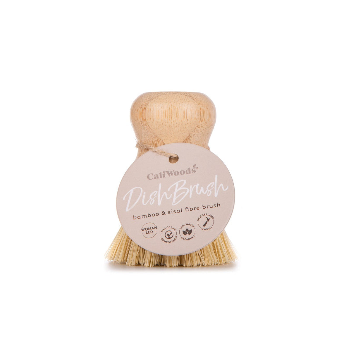 A beige dish brush with natural bristles and a bamboo handle, with a brand label attached to the handle.