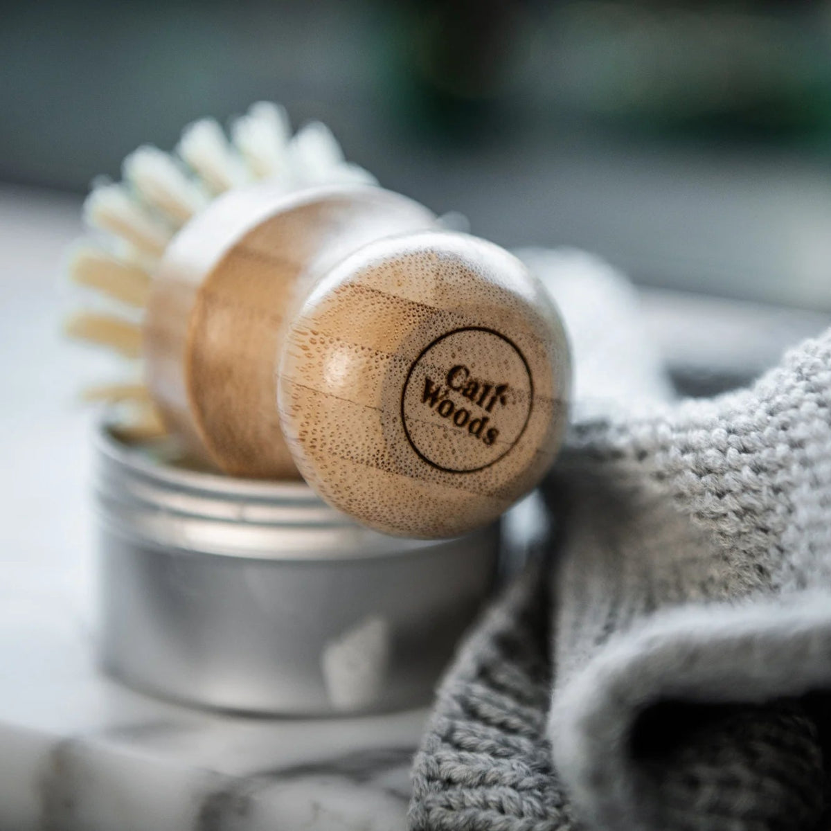 Wooden brush with Caliwoods logo on a blurred background