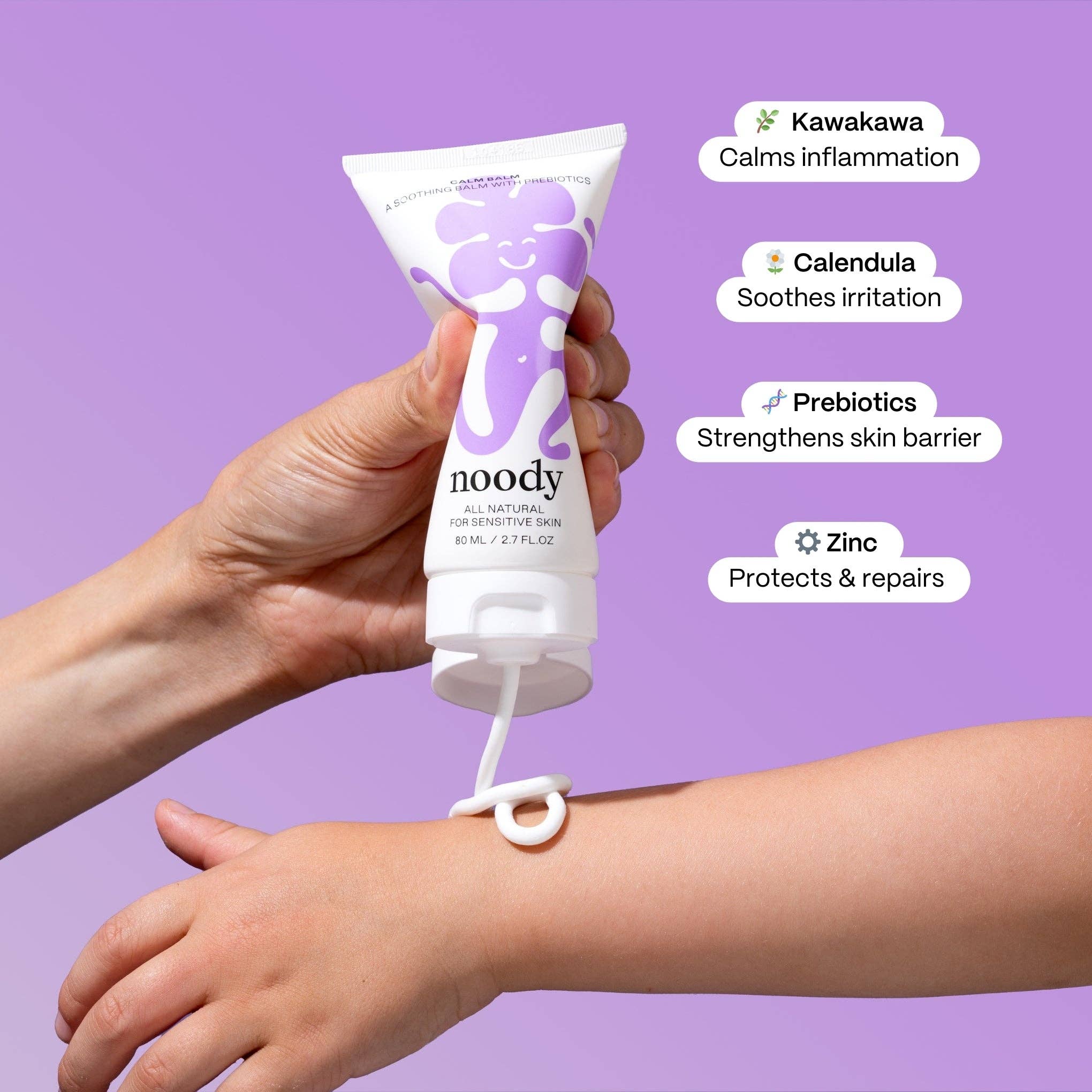 Hand applying noody cream to a wrist with purple background and text highlighting ingredients.