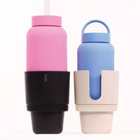 Two reusable water bottles sitting in car cup holders with colourful silicone sleeves on a white background