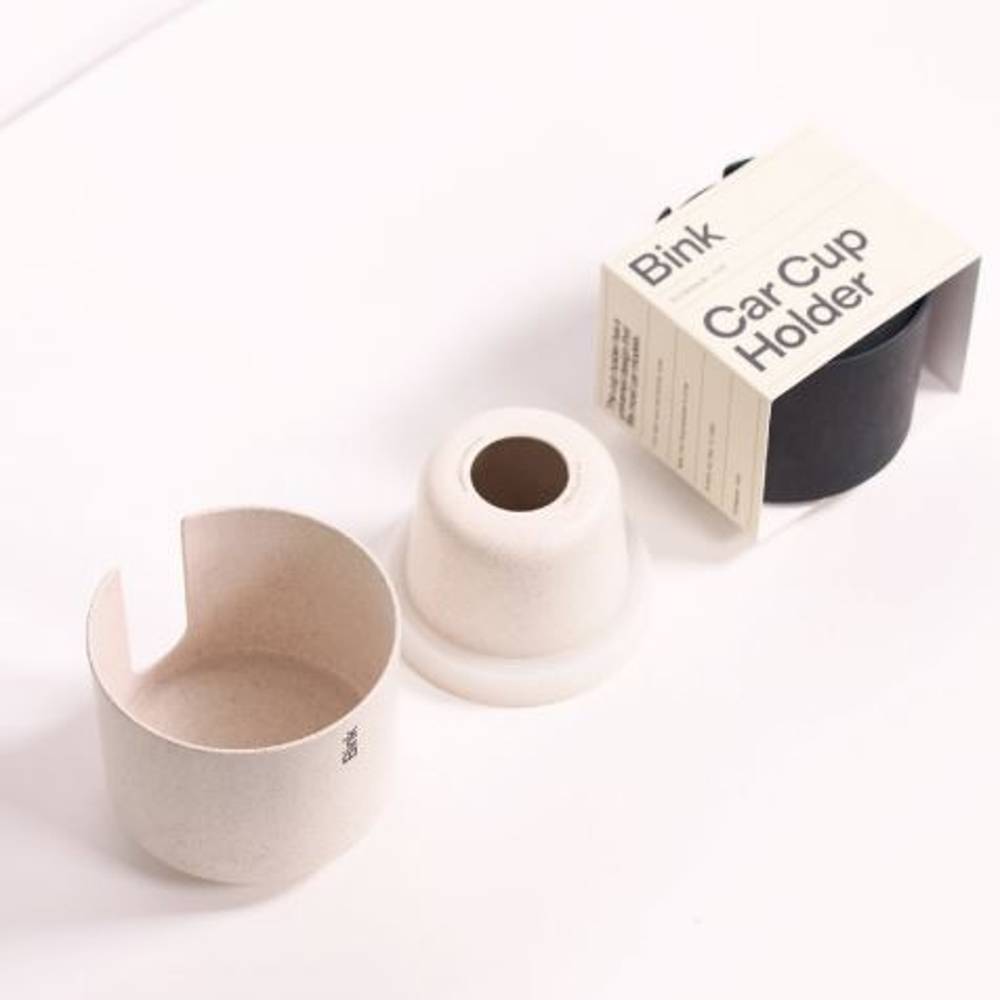Straw and Charcoal coloured car cup holder with packaging labelled 'Bink' on a white background