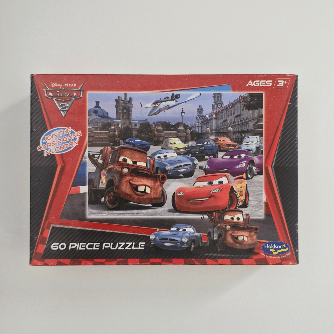 Puzzle box featuring Disney Pixar Cars characters on a gray background