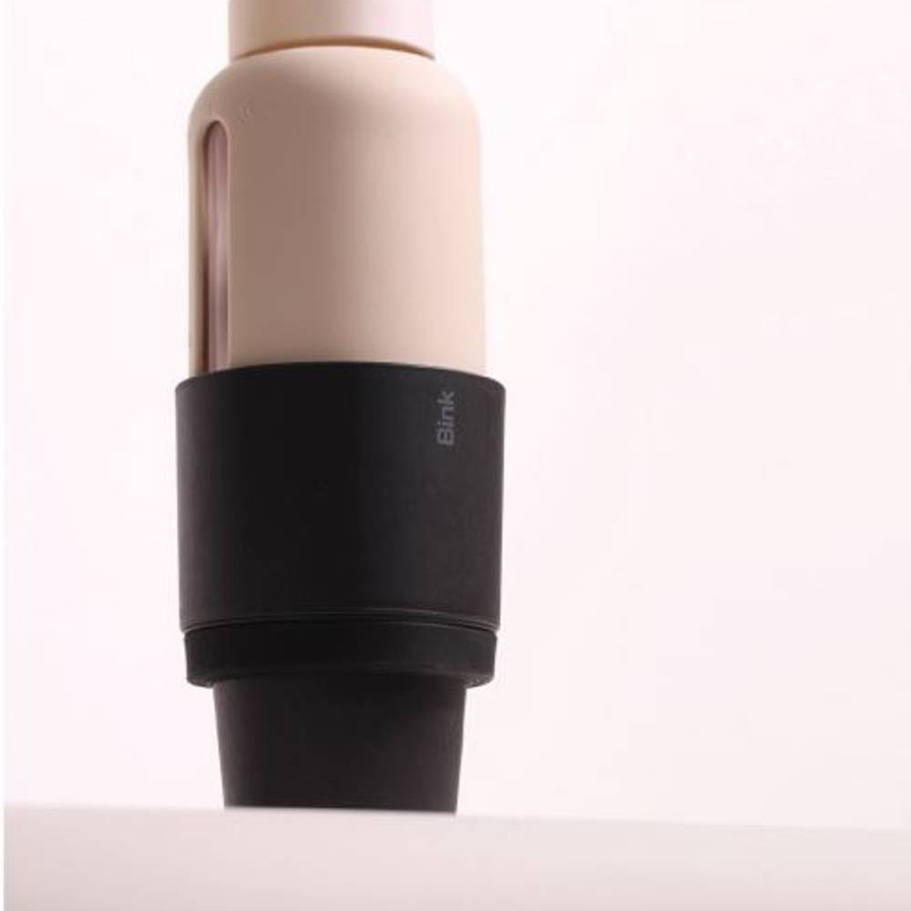 Beige water bottle with a black car cup holder on a white background