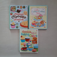 Three children's cookbooks on a gray surface