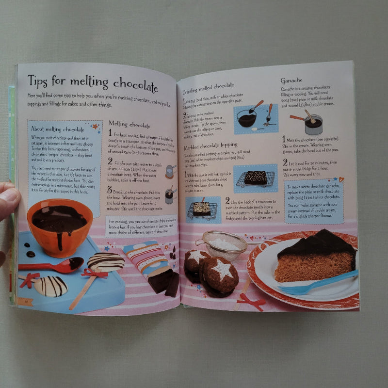 Open book with cooking instructions and illustrations on a plain background