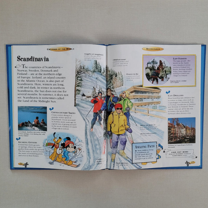Open book with illustrations and text about Scandinavia on a flat surface