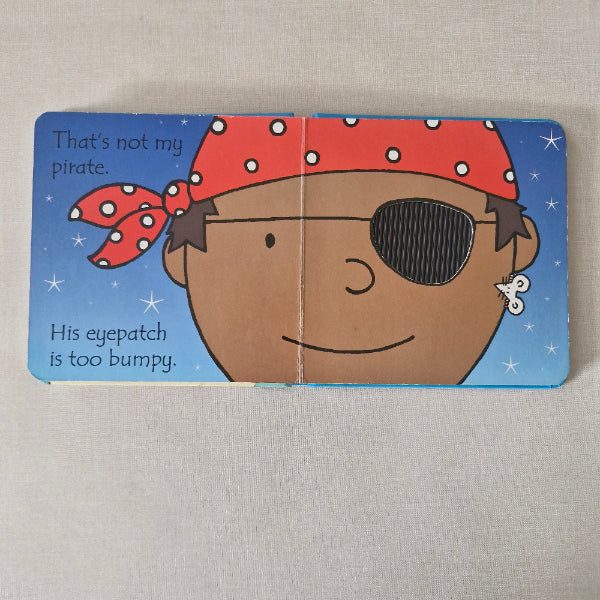 Children's book with a pirate-themed illustration on a textured surface