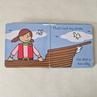Children's book page with a pirate-themed illustration on a beige background