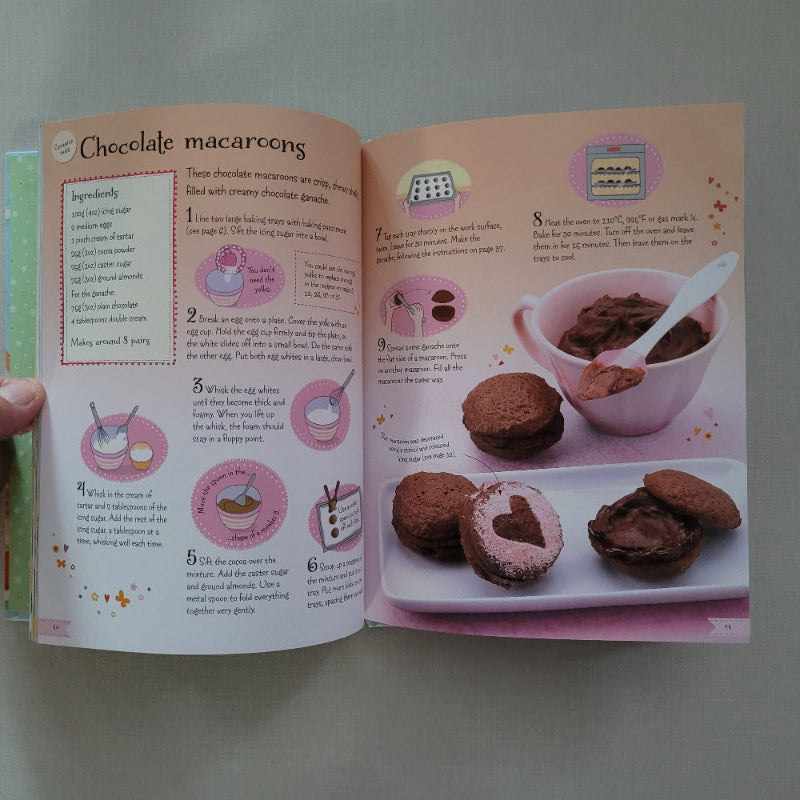 Open book showing a recipe for chocolate macarons with illustrations and text.