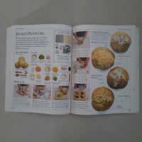 Open book with recipes and images of food on a gray background