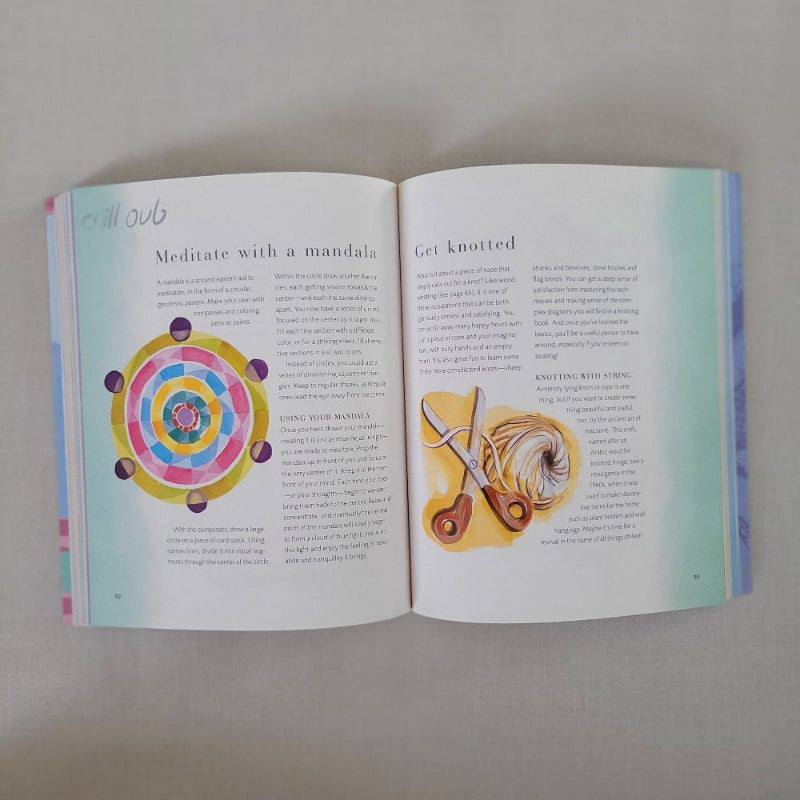 Open book with illustrations of yarn and scissors on one page and a colourful mandala on the other, on a light gray background.