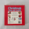 Red book back titled 'Christmas Cakes and Cookies' on a grey background