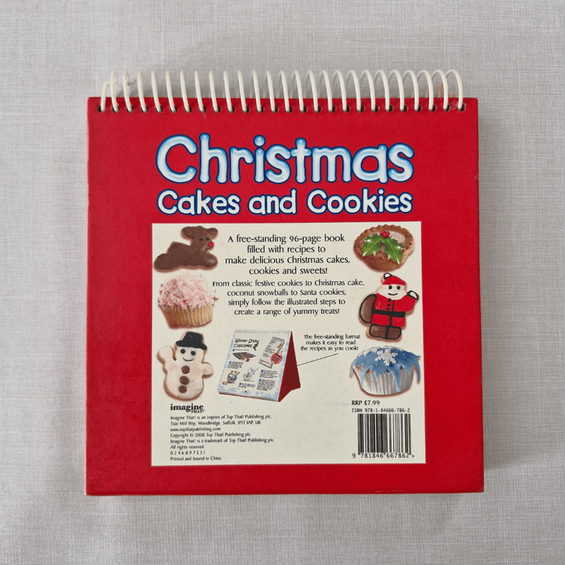 Red book back titled 'Christmas Cakes and Cookies' on a grey background