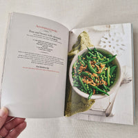 Open cookbook showing a page with a bowl of green beans and peas.