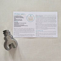 Cookie Recipe Card with metal cookie cutter on plain background