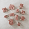 Set of small rubber stamps with various designs on a light background
