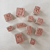 Set of small rubber stamps with various designs on a light background