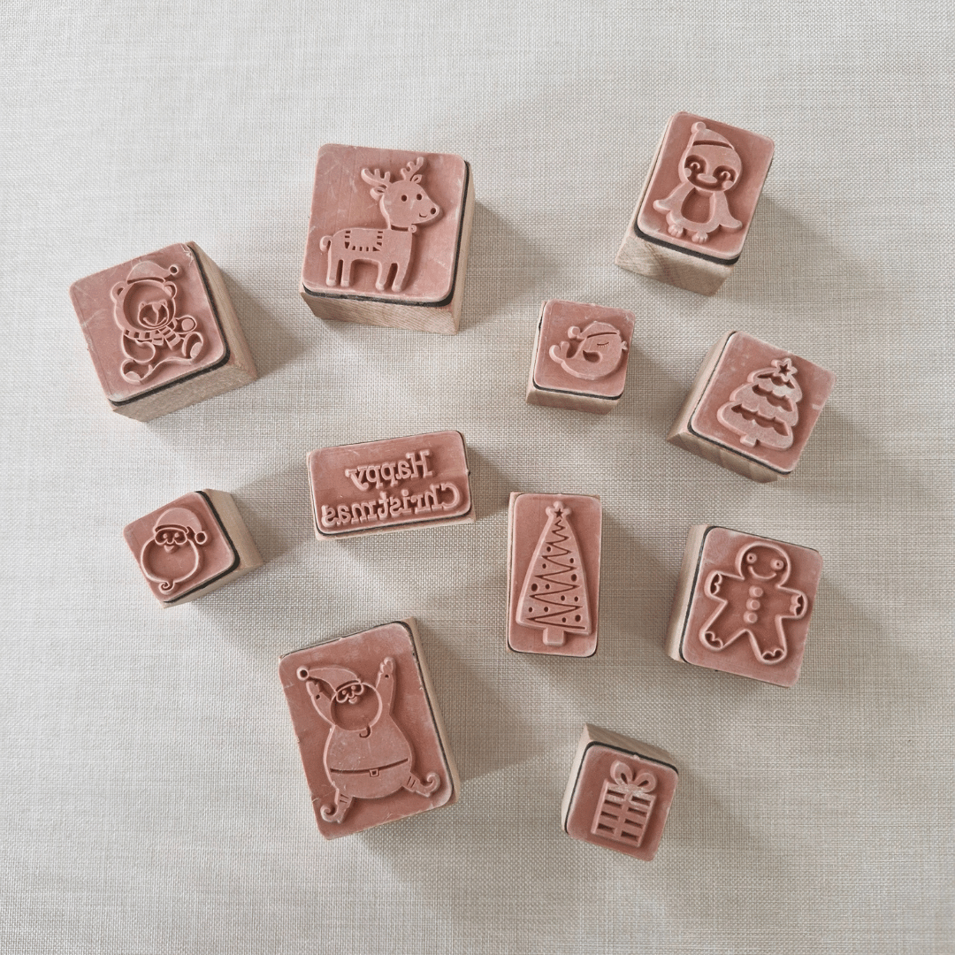 Set of small rubber stamps with various designs on a light background