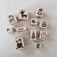Set of Christmas-themed wooden stamps on a textured surface