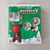 Box of reindeer-themed Christmas socks on a beige surface