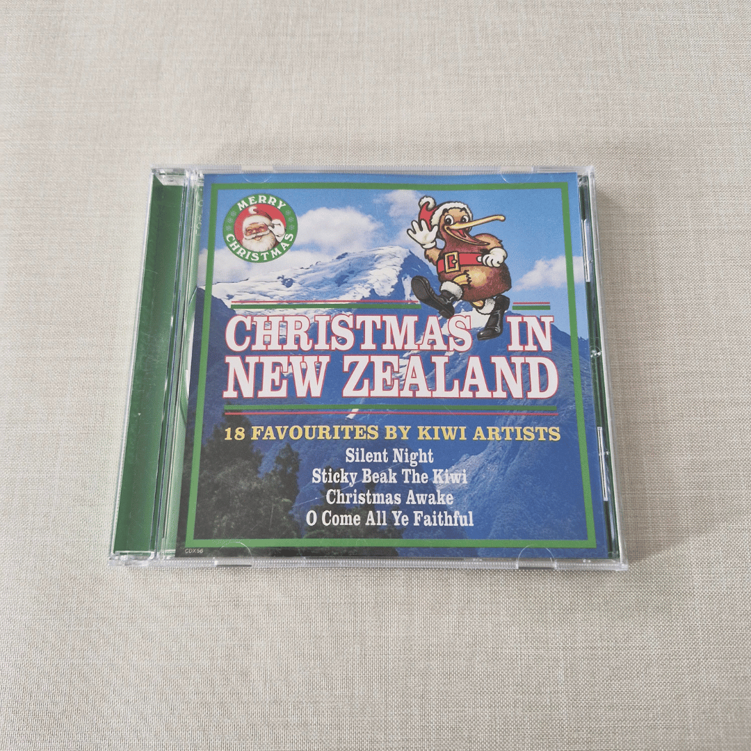 CD cover of 'Christmas in New Zealand' featuring a Santa Claus illustration on a textured surface.