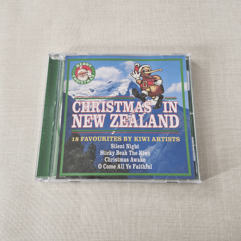 CD cover of 'Christmas in New Zealand' featuring a Santa Claus illustration on a textured surface.