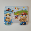 Wooden toy puzzle with vehicles on a colorful background