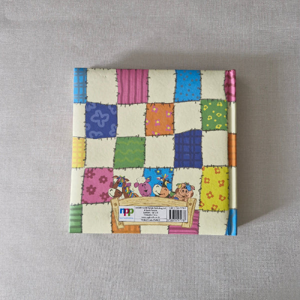 Colourful patchwork-style box with cartoon characters on a gray background