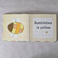 Children's book with a bumblebee illustration and text on a gray background