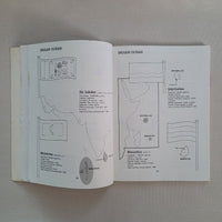 Open book with diagrams and text on a plain background