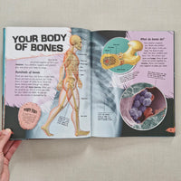 Open book showing educational content about bones and cells on a neutral background