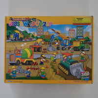 Construction-themed jigsaw puzzle box with colourful illustrations on a white background