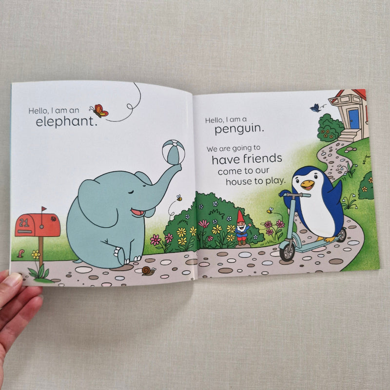 Open book with illustrations of a penguin and an elephant on a textured surface