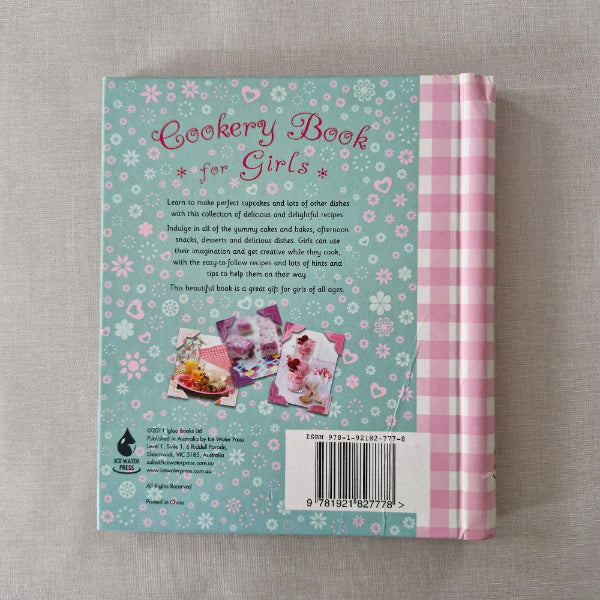 Back cover of a book with floral design and text on a gray surface