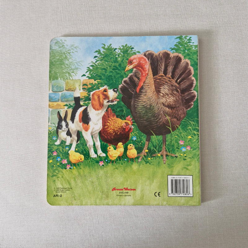Children's back book cover with farm animals illustration on a textured surface