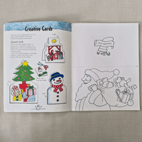 Open book with Christmas-themed colouring pages/cards and instructions on a textured surface