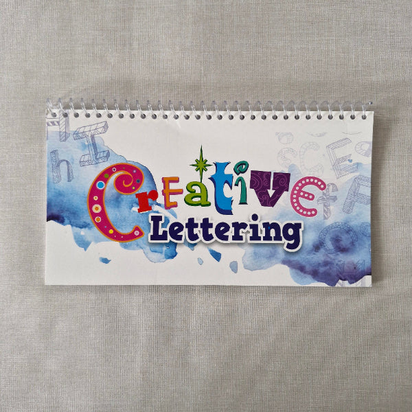 Notebook with 'Creative Lettering' design on a textured surface