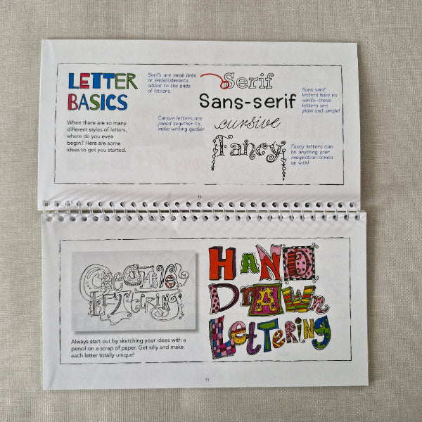 Open book with text and design on a textured surface