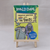 Book titled 'Creative Writing with The Twits' by Roald Dahl on a small easel against a grey background