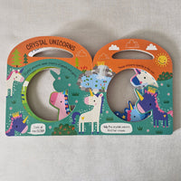 Colourful children's book with unicorn illustrations on a textured surface