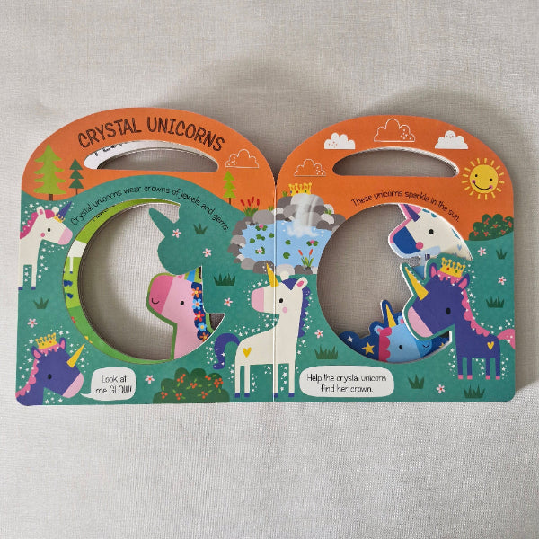 Colourful children's book with unicorn illustrations on a textured surface