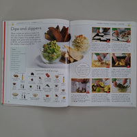 Open book with food illustrations and text on a plain background