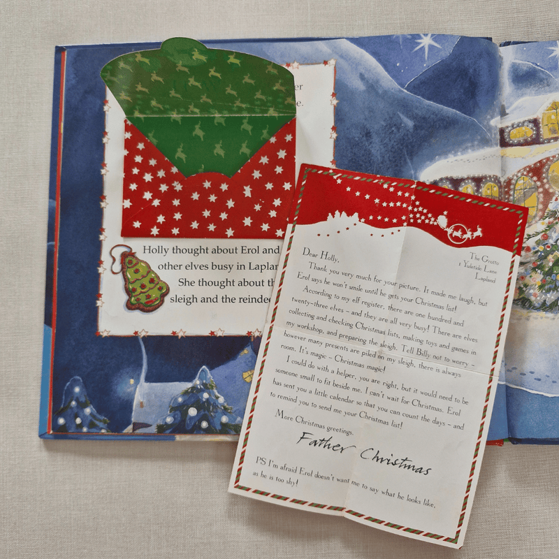 Christmas-themed letter from Father Christmas with a red envelope on a textured surface