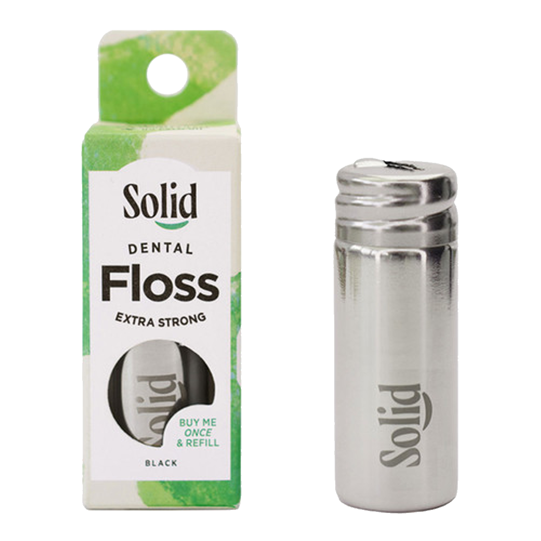 Solid dental floss packaging and stainless steel container on a white background
