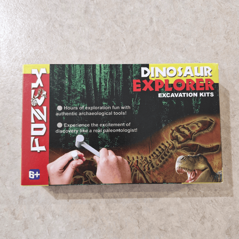 Dinosaur Explorer excavation kit packaging on a textured surface